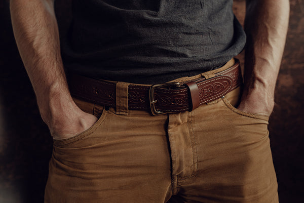 Male model wearing brown wide celtic design belt