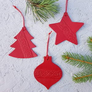 Set of three red leather christmas tree decorations with a celtic knot design
