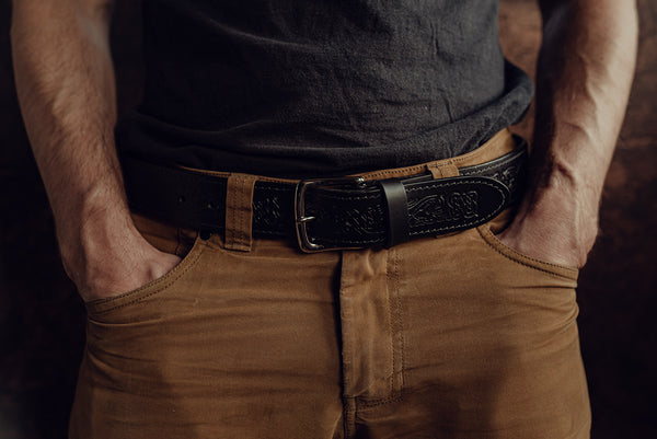 Male model wearing wide black dragon embossed belt