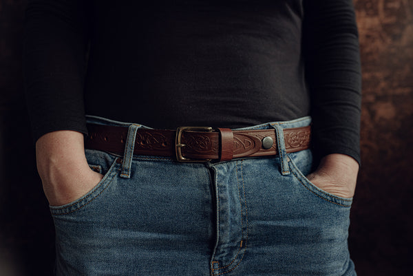 Female model wearing brown leather belt with ce;ltic design