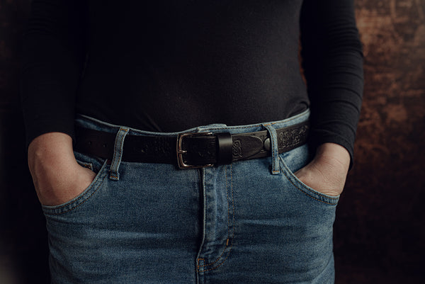 Lady wearing narrow black dragon celtic belt with jeans