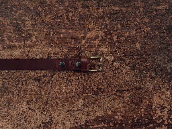 Brown leather belt with brass buckle